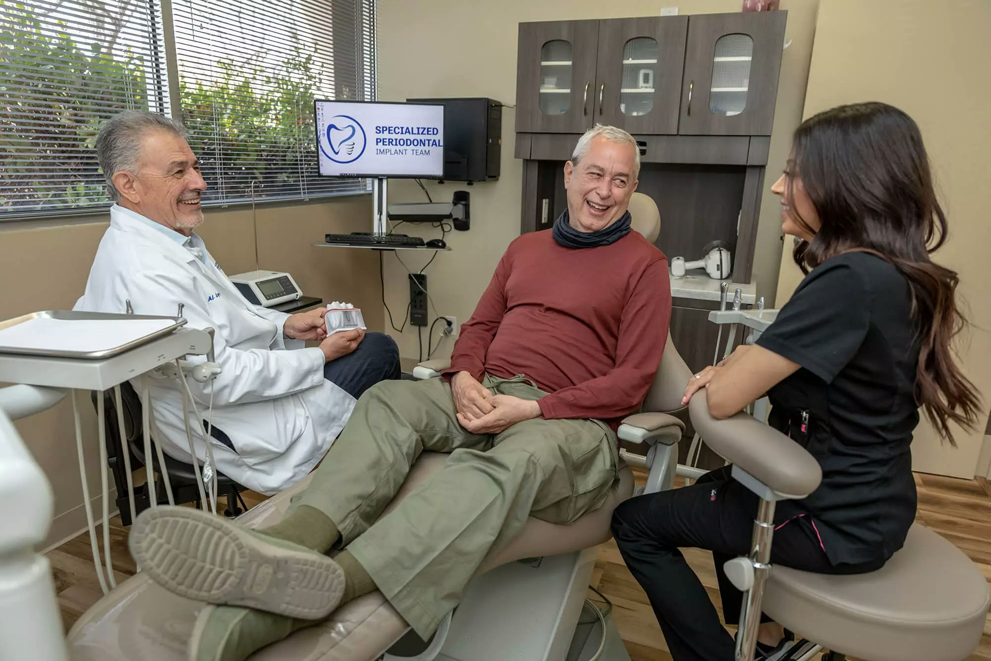 smiling patient in chair with dentist