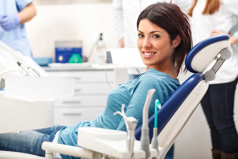 a dental patient smiling after her sedation dentistry
