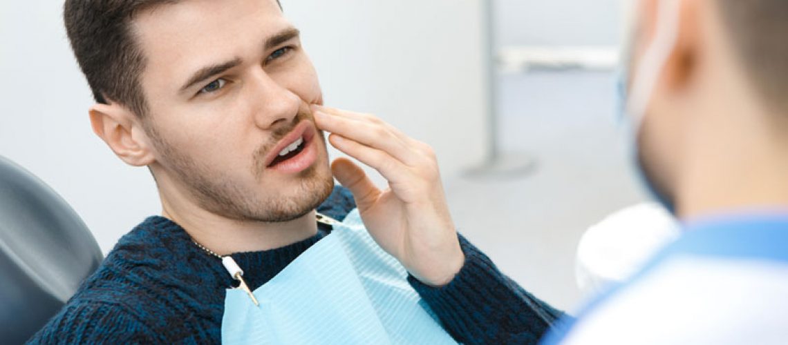 Dental Patient Suffering From Mouth Pain On A Dental Chair, In Albuquerque, NM