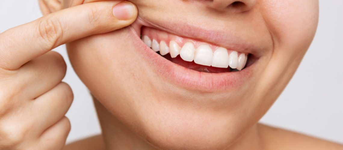 Cropped shot of a young woman showing healthy gums.
